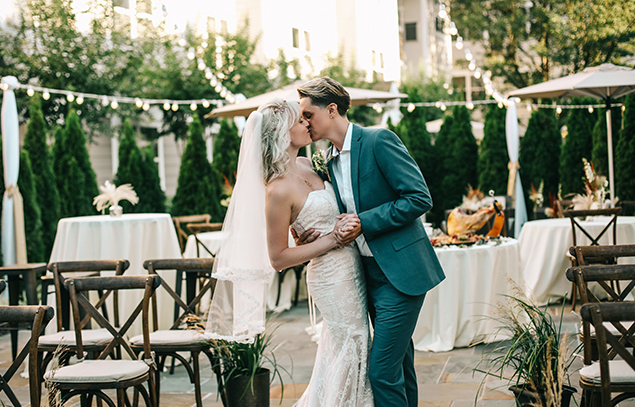 bride and groom kissing at their wedding at Sonesta Hotels
